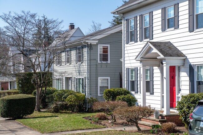 Colonial style homes line Oak Hill's streets amongst budding trees.