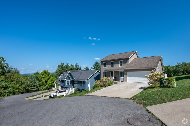 A row of newly constructed homes stand out on the hills of Cheat Lake.