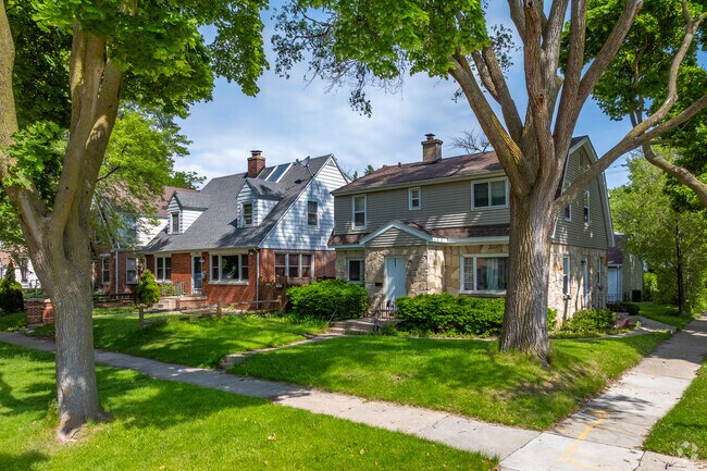 A colonial and cape cod home surrounded by mature trees in Nash Park.