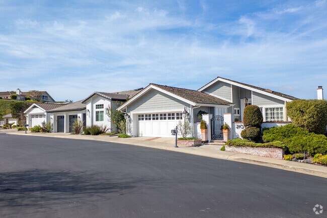 A row of modern ranch homes in Broadmoor Sea View combines stylish design with coastal charm, offering open spaces and serene living in Newport Beach's exclusive neighborhood.