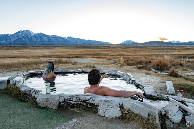Whitmore Hotsprings visitors take in the sunset while chatting about the day spent in Mammoth Lakes.