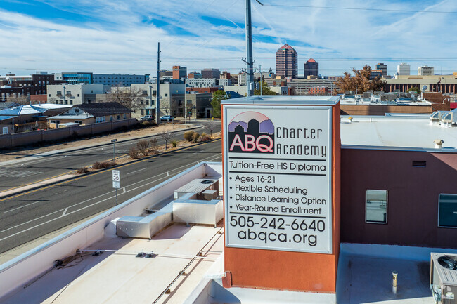 ABQ Charter Academy sign with downtown Albuquerque in the background.