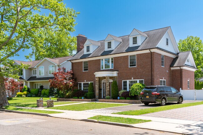 Massive colonial-style homes like this all brick can be found across Herricks suburbs.