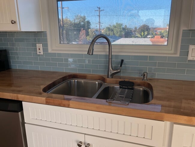 Beautifully sealed butcher block counter tops and 2-tub kitchen sink with disposal. North facing window.