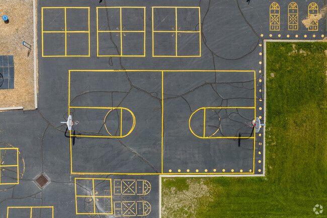 A basketball court amid other blacktop games at Liberty Elementary School.