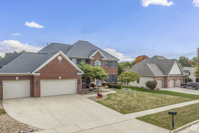 Contemporary Colonial Revival homes often feature expansive lawns and brick facades.
