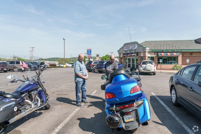 A friendly motorcycling club takes advantage of the nice weather to meet up for breakfast at Round the Clock Diner near Elmwood.