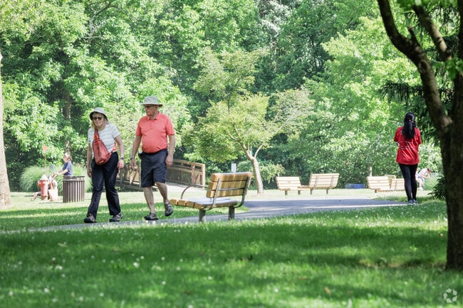 People enjoying a shaded walk at Van Saun County Park in Paramus.