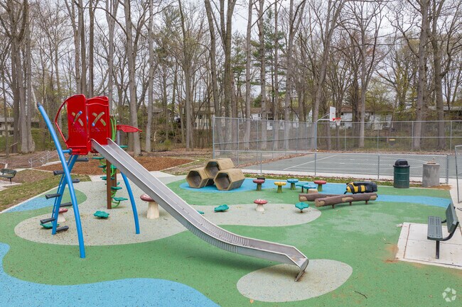 Newly renovated playground with basketball court in background of Jaycee Park in Ridgebrook