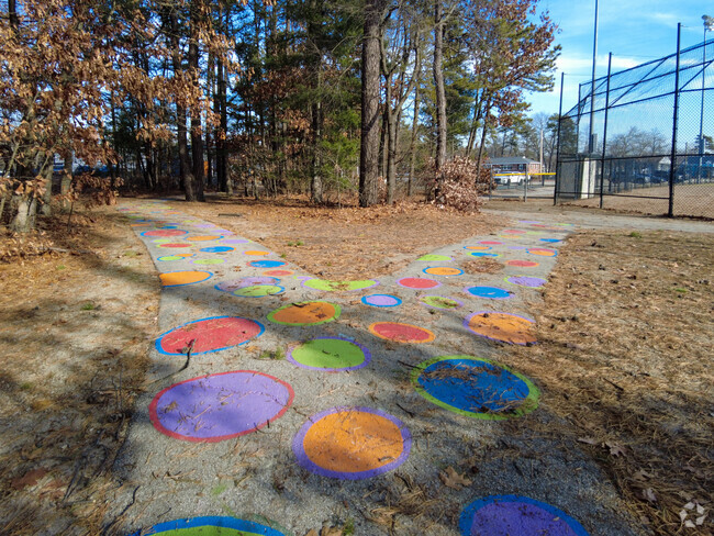 Colorful chalk murals adorn a sidewalk at Ledge Street Elementary School.