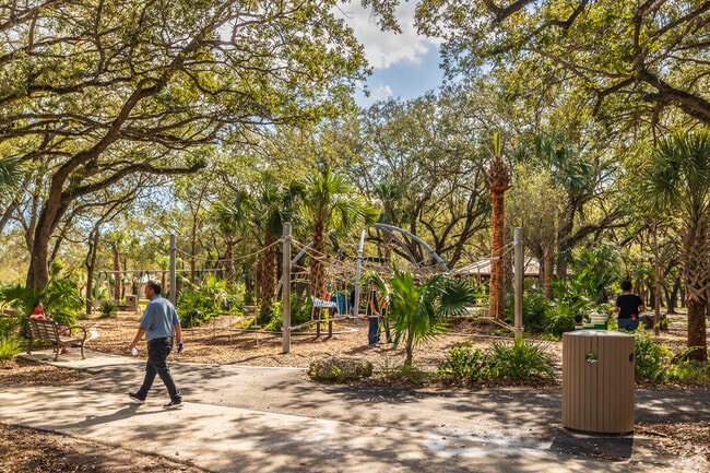 Children climb and play on the jungle gym at Kendall Indian Hammock Park near The Crossings.