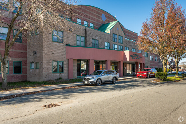 Few cars parked in front of Delsesto Middle School's main entrance located in Providence.