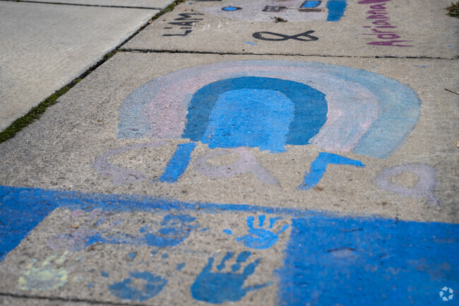 In Memphis kids paint the sidewalk outside the Memphis Library.
