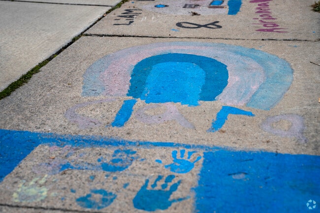 In Memphis kids paint the sidewalk outside the Memphis Library.