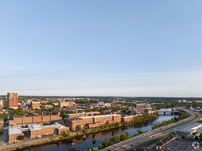An aerial view captures the Merrimack River winding through the heart of downtown Manchester.