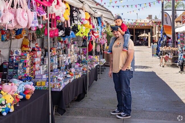 A young Casa Loma father enjoys time with his son at the nearby Plaza Del Pueblo.
