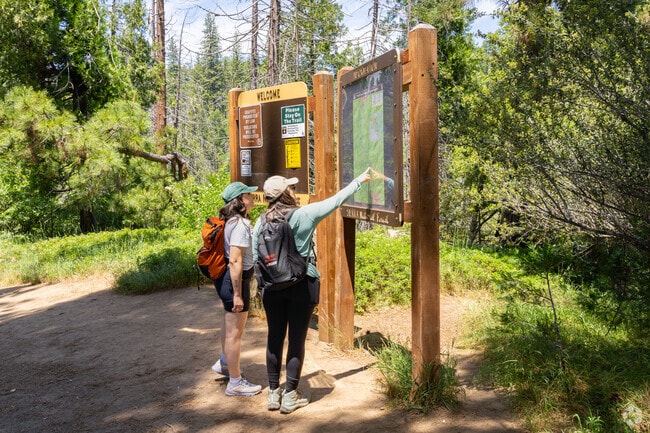 Oakhurst visitors plan out their hike at the Lewis Creek National Trail.