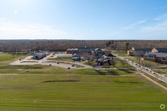 There is a lot of farmland next door to Bristol County Agricultural High School.