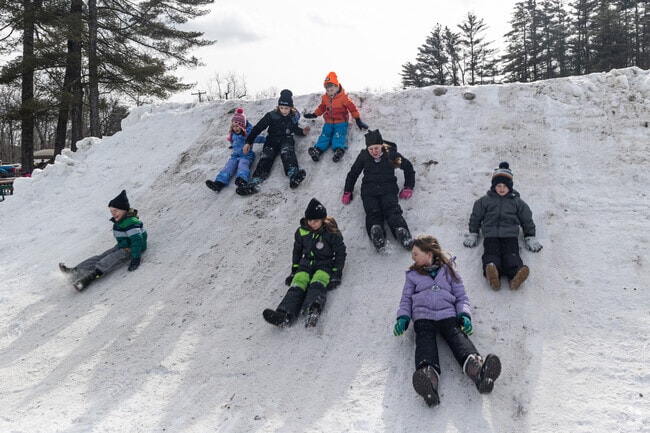 Snowy days in Denmark bring joy to playful children.