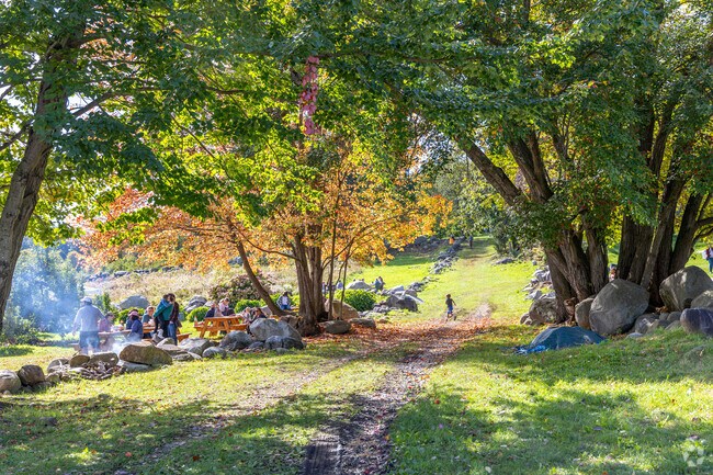 Families and children play under the fall foliage around Drew's Farm in Westford, MA.