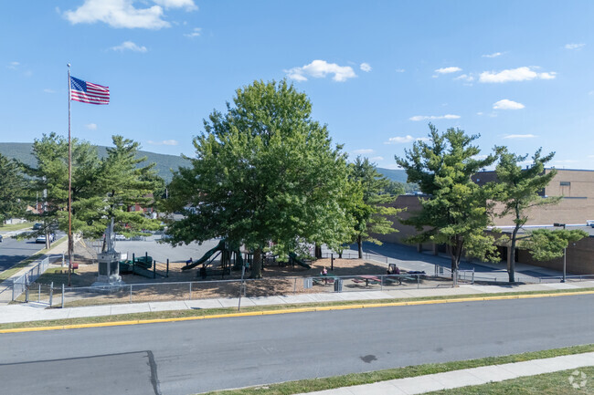 The playground at the Juniata Elementary School is modest, but a memorial is at its corner.