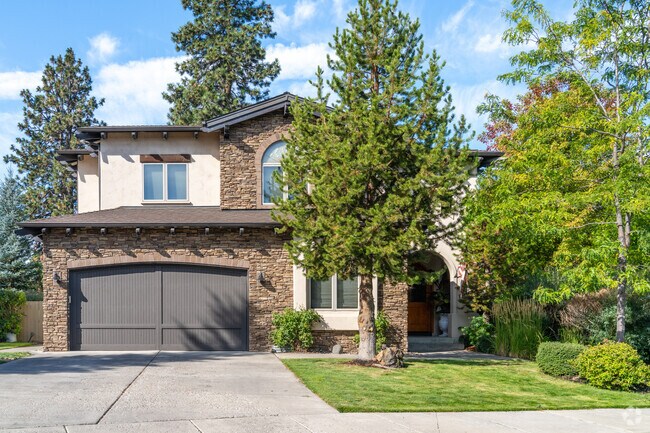 Modern home in Southwest Bend, boasting a cozy porch, lush garden, and an inviting exterior.