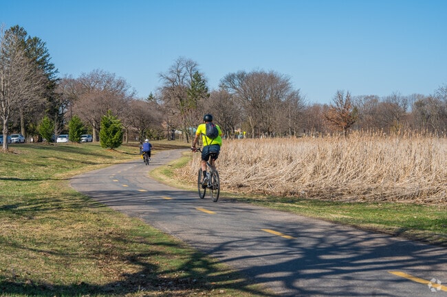 Bikers make their way along the lake path near Keewaydin.