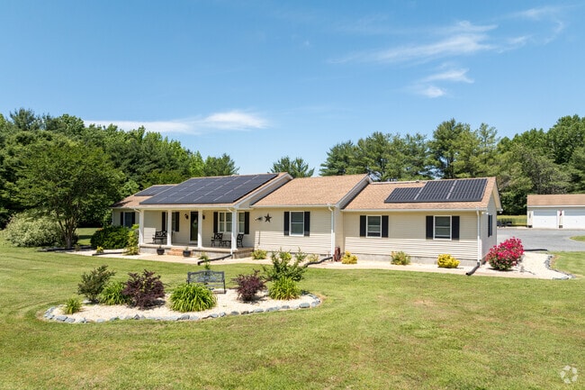A Hebron ranch home features solar panels to catch the afternoon sun and convert it to electricity.