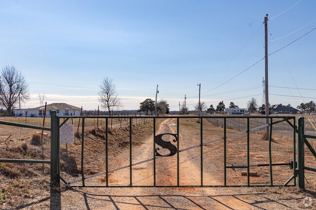 Just beyond this gate sits Osiyo Buffalo Creek Berry Farm in Mustang.