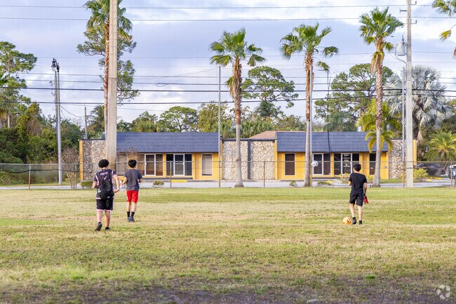 Kids from the Greenacres community center gathering on the soccer field.