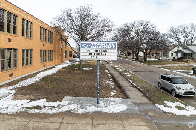 There is a sign for Stanley Elementary School near the main road.