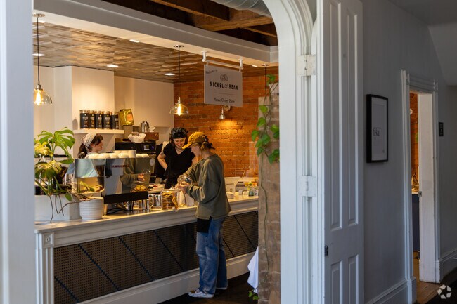 Locals grab coffee at Nickel and Bean, a cozy spot known for its warm vibe and strong brews.
