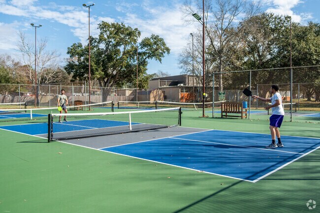Residents of New Iberia enjoy a sunny day playing pickleball at City Park.