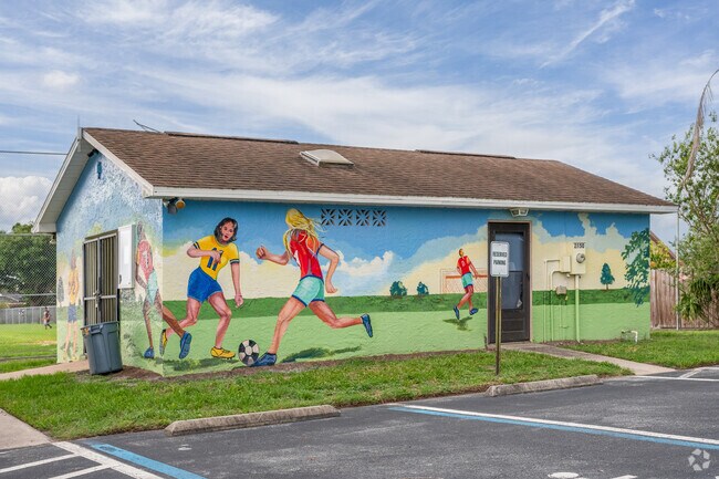 A vibrant mural sits by the ball field at Whisper Lakes Estates Recreation Park.