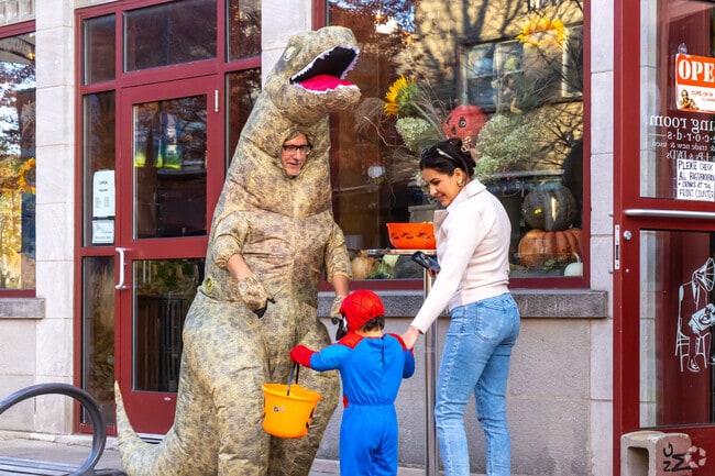 Kids in costumes beam with excit as they collet treats and explore Uptown Normal together.