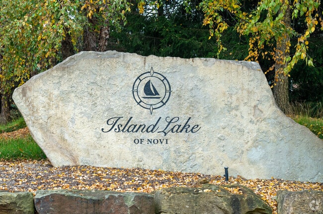 A neighborhood sign welcoming residents to Island Lake.