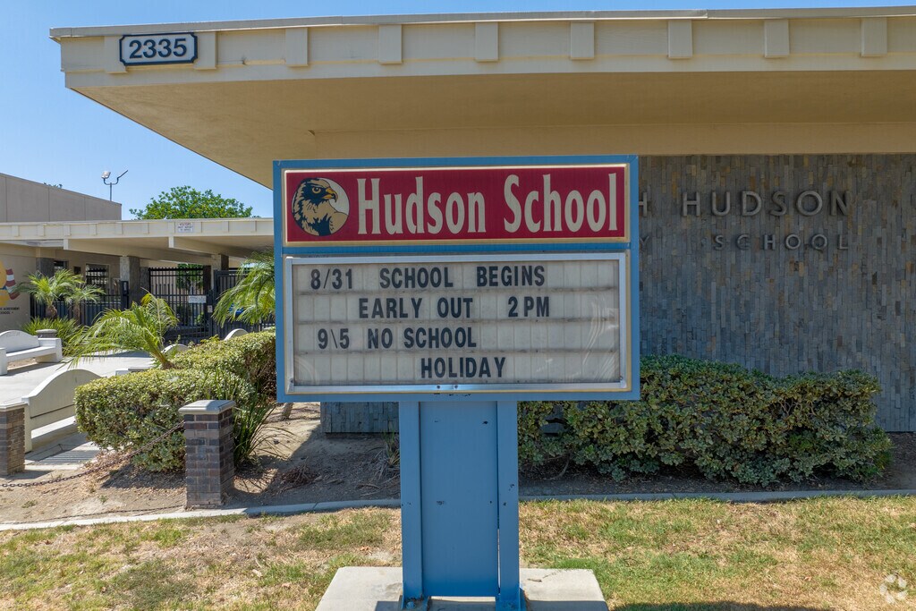 Hudson Elementary School's entrance sign displays the times for school and weekly schedule.