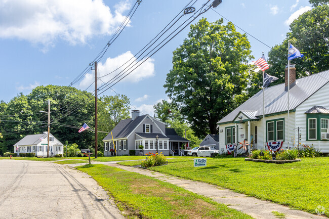 A row of well-maintained homes sits near the town center of Hill.