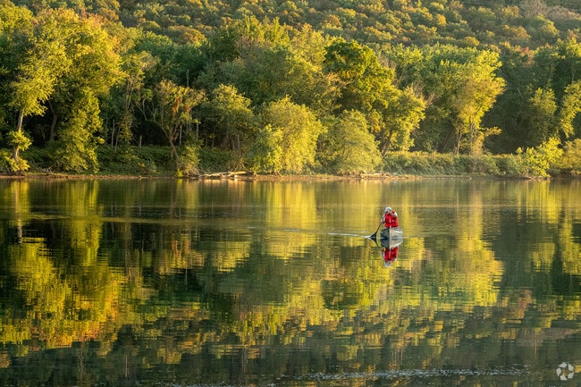A man peacefully paddle his canoe along the calm waters of the Susquehanna River.