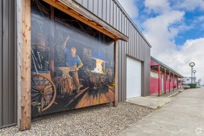 A hand-painted mural depicting a metal worker in Sublimity, OR.