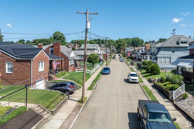 Small and large residential houses line the streets of Springdale on small lots.