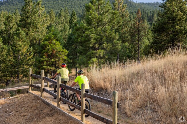 Two mountain bikers embark up Mount Ascension from the Beattie Street Trailhead.