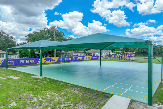 Lomax Magnet Elementary School has outdoor shaded basketball courts for recess.