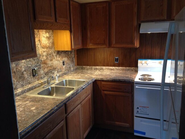 Kitchen sink, cabinets, stove