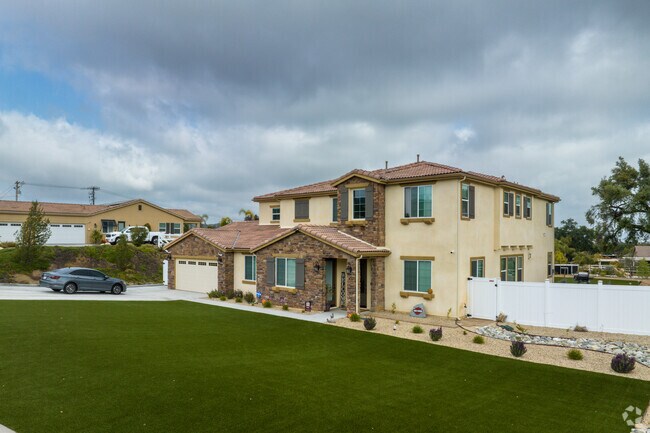View of a beautiful two story home with a spacious green lawn in Paloma Valley CA.