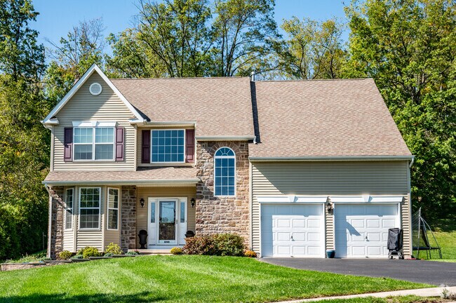 Beautiful stone faced two story homes are surrounded by trees in East Rockhill.