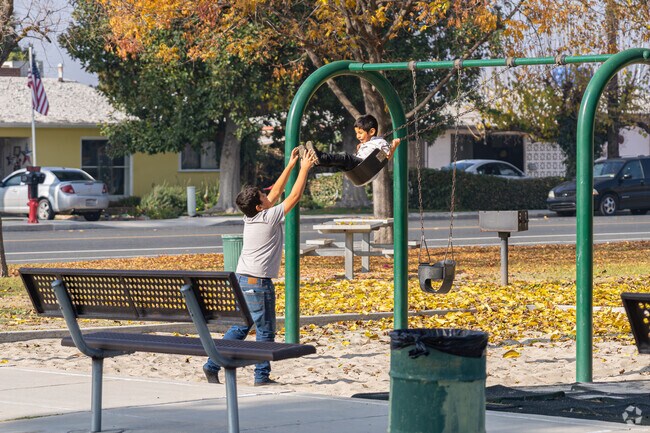 Two Downtown Delano brothers enjoy swinging at Memorial Park.