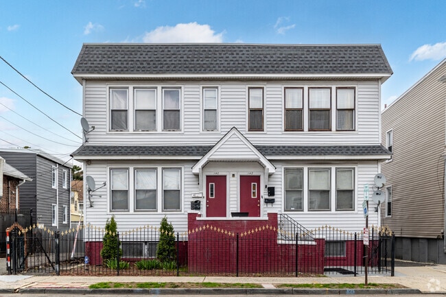 Many multifamily homes in Upper Vailsburg feature dual entrances and decorative front fences.
