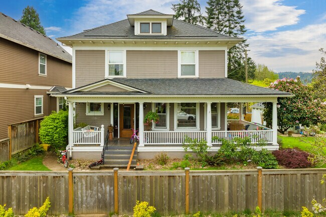 A Four Square home with wrap around porch in  the Cathedral Park Neighborhood.