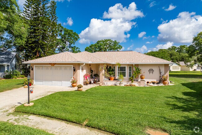 This Heritage Lake home has brick features and colorful plants to make it sparkle.